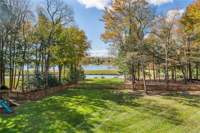 view of yard with a water view and a playground