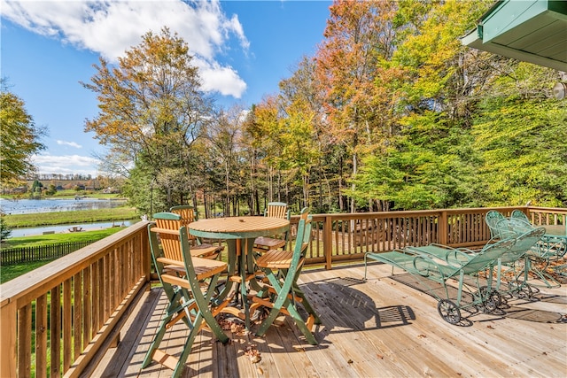 wooden terrace featuring a water view