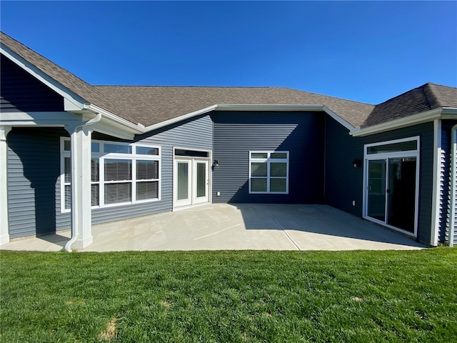 rear view of property with a patio and a yard