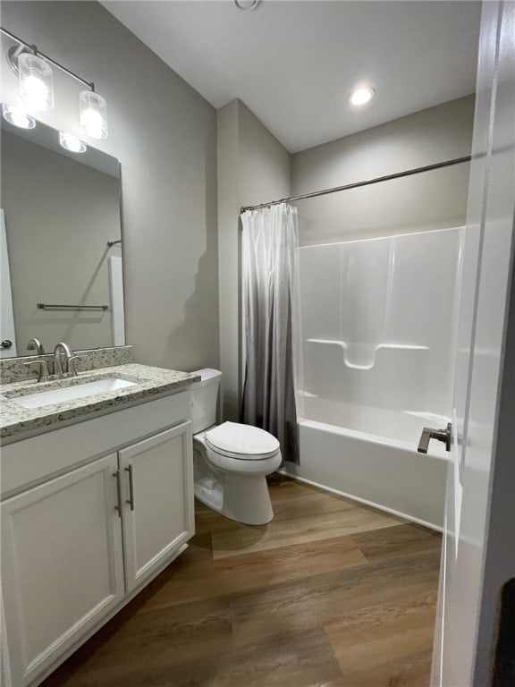 full bathroom featuring shower / bath combo, vanity, toilet, and hardwood / wood-style flooring