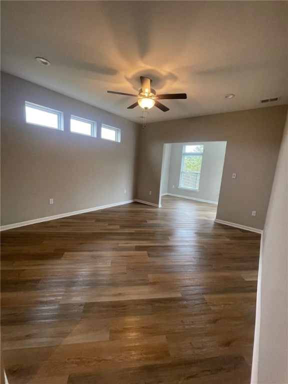 unfurnished room with dark hardwood / wood-style flooring and ceiling fan