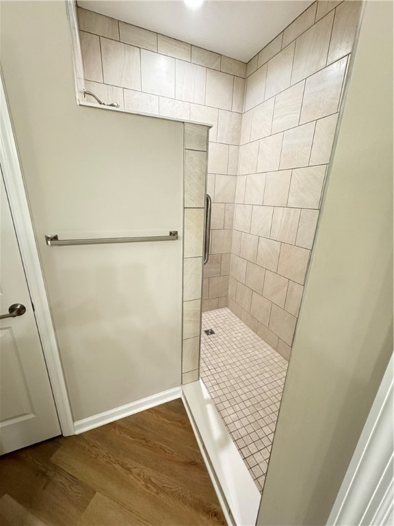 bathroom featuring hardwood / wood-style flooring and an enclosed shower