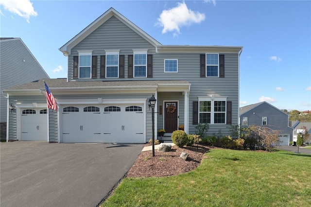 view of front of property featuring a front yard and a garage