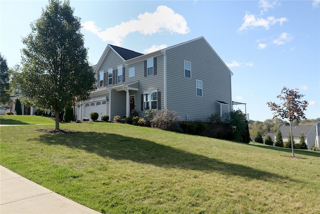 view of front of home with a front yard and a garage