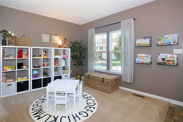 recreation room with light carpet