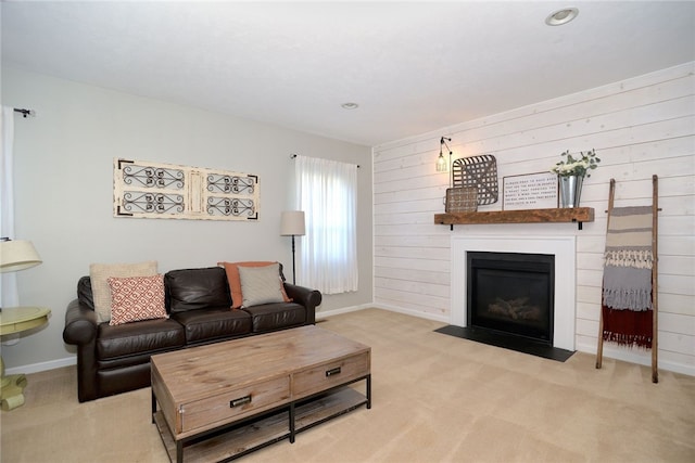 living room with wood walls and light carpet