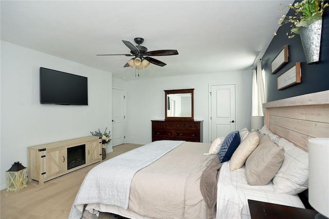 bedroom with ceiling fan and light colored carpet