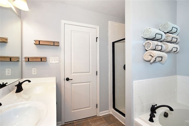 bathroom with vanity and independent shower and bath