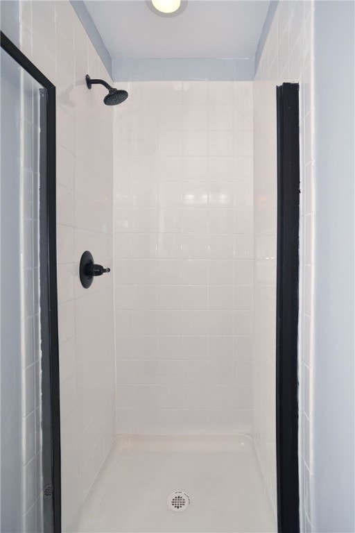 bathroom with tiled shower