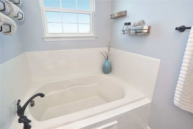 bathroom with a relaxing tiled tub