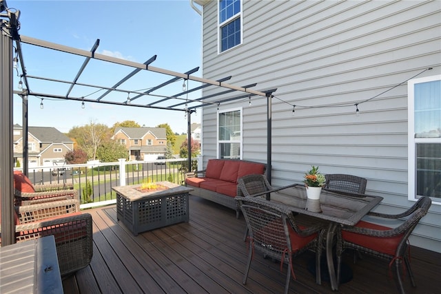 wooden terrace featuring a pergola and an outdoor living space with a fire pit