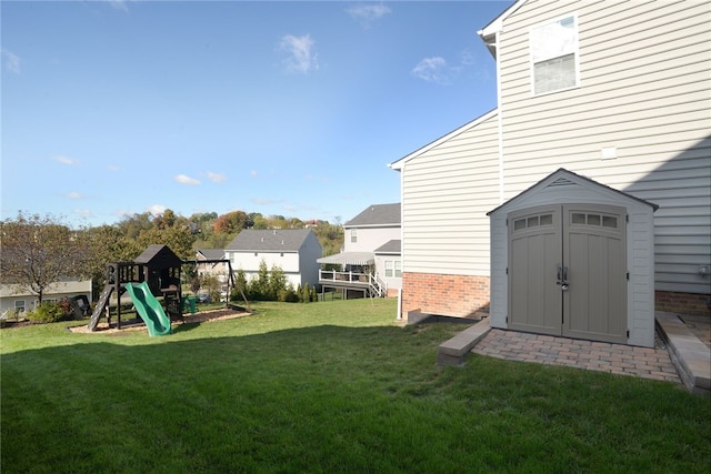 view of yard with a playground and a storage unit