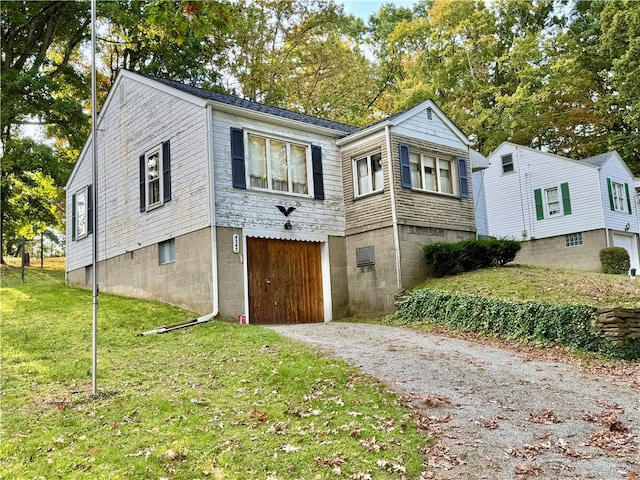 view of front of property with a garage and a front yard