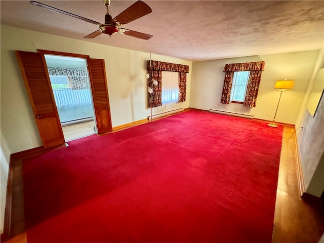 unfurnished living room with ceiling fan and a baseboard radiator