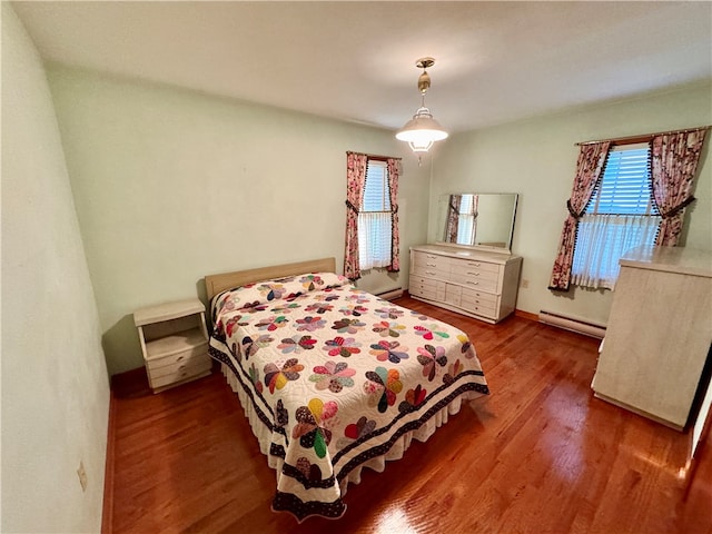 bedroom featuring a baseboard radiator and hardwood / wood-style floors