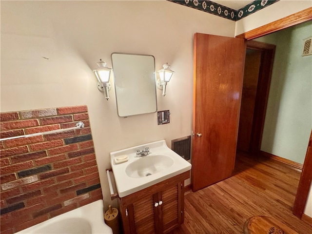 bathroom with hardwood / wood-style flooring and vanity