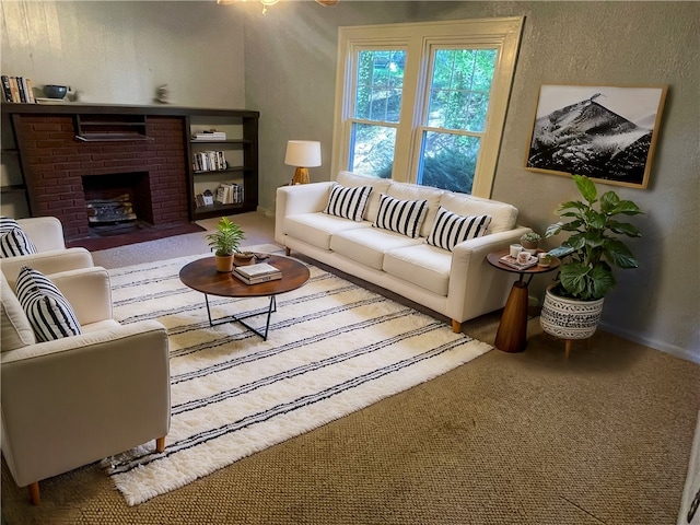 living room with carpet floors and a fireplace