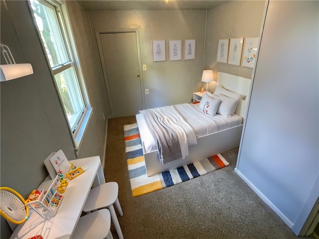 bedroom featuring dark colored carpet