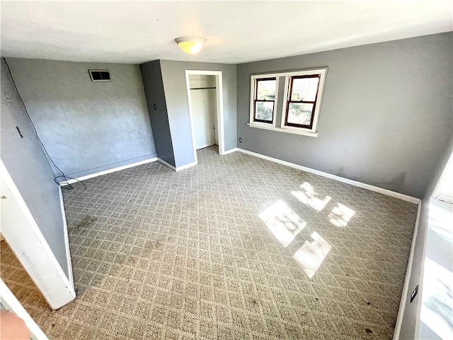 unfurnished bedroom with a closet and carpet flooring