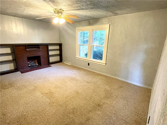 unfurnished living room featuring ceiling fan, a textured ceiling, and light carpet