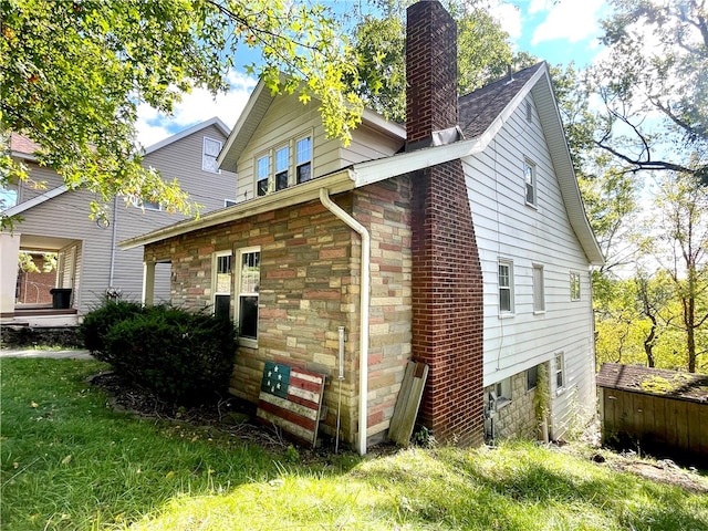 view of side of home featuring a lawn