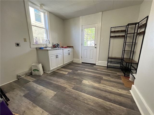 laundry area with sink, dark wood-type flooring, electric dryer hookup, and cabinets