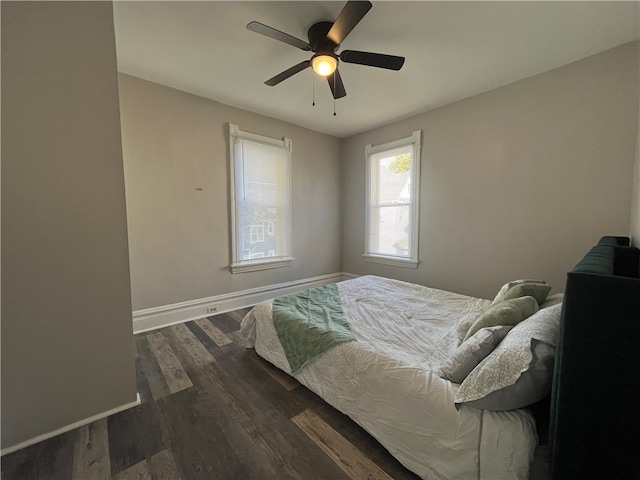 bedroom with dark wood-type flooring and ceiling fan