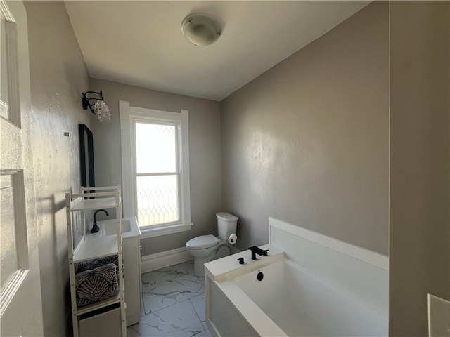 bathroom with vanity, toilet, and a bath