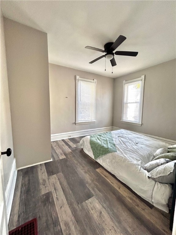 unfurnished bedroom with dark wood-type flooring and ceiling fan