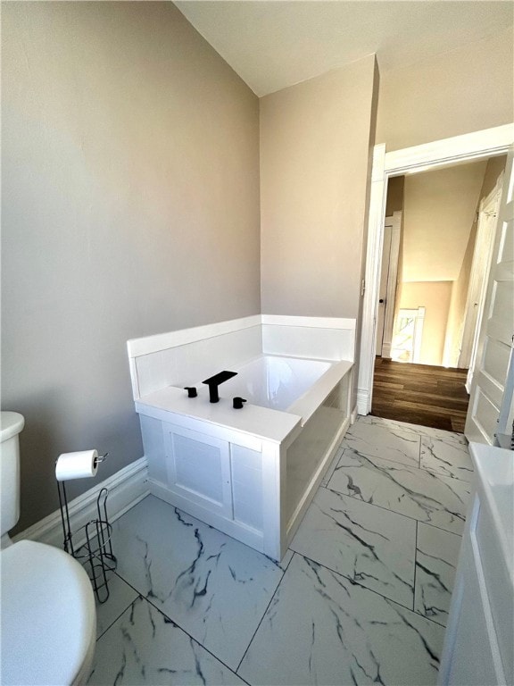 bathroom with a bathing tub and toilet