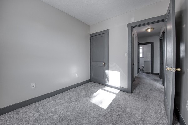 unfurnished bedroom with light colored carpet