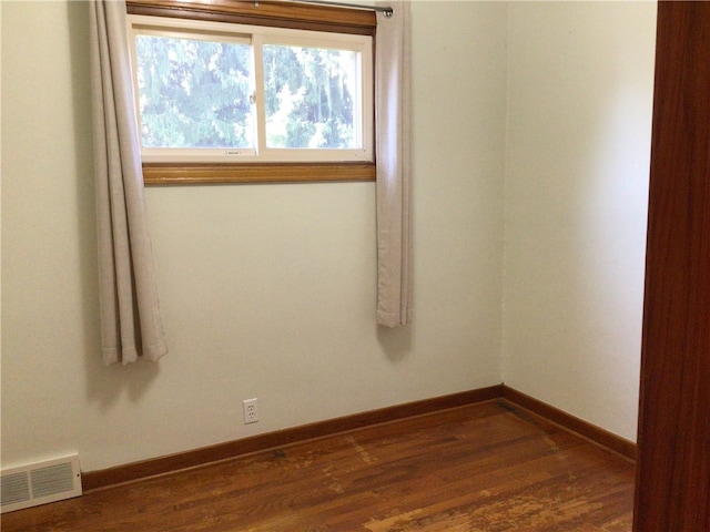 spare room featuring dark wood-type flooring