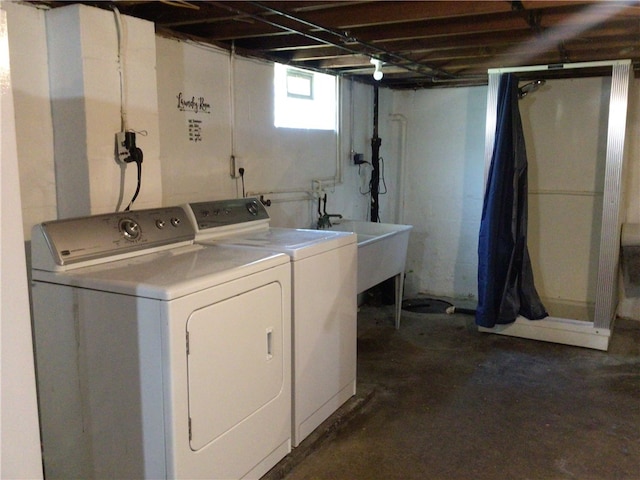 washroom with separate washer and dryer and sink