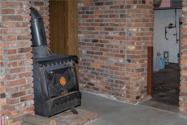 interior details with concrete floors and a wood stove