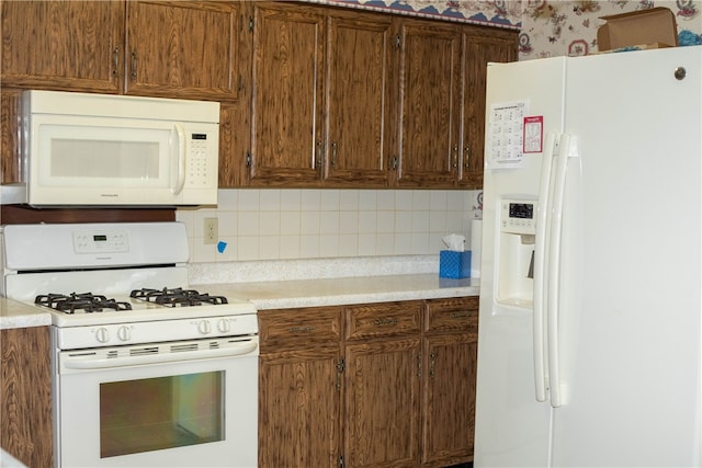 kitchen with tasteful backsplash and white appliances