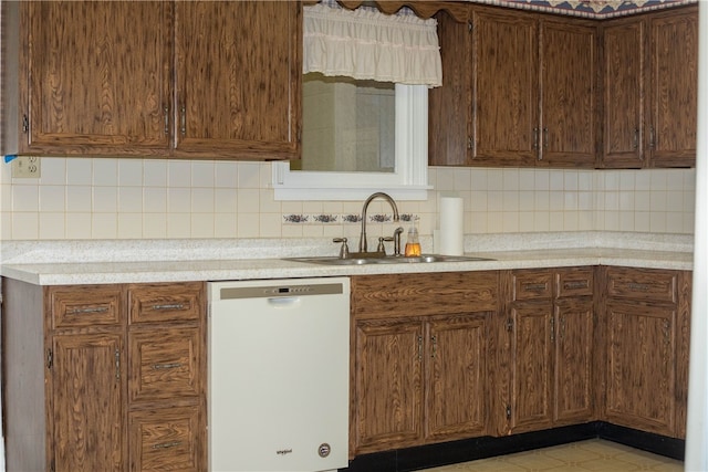 kitchen with dishwasher, sink, and tasteful backsplash