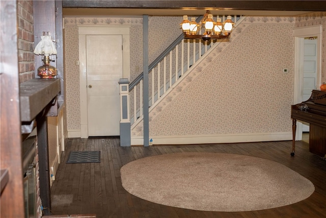 entrance foyer with a chandelier and dark hardwood / wood-style flooring