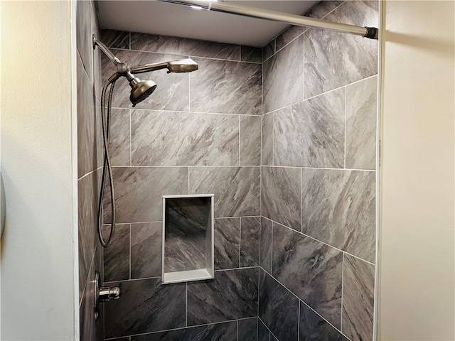 bathroom with a tile shower