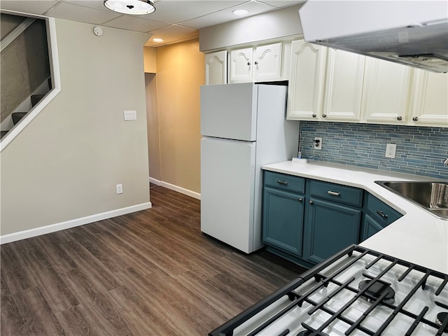 kitchen featuring dark hardwood / wood-style floors, white cabinetry, sink, and white refrigerator