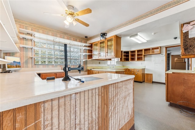 kitchen featuring kitchen peninsula and ceiling fan