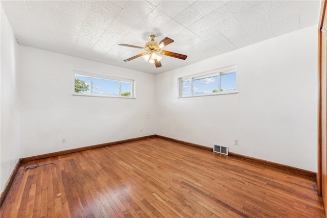 spare room with ceiling fan and hardwood / wood-style floors