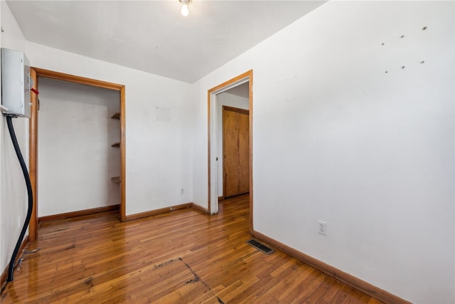 unfurnished bedroom with hardwood / wood-style floors