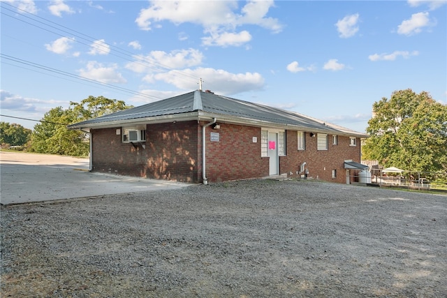 view of front of house featuring a wall mounted AC