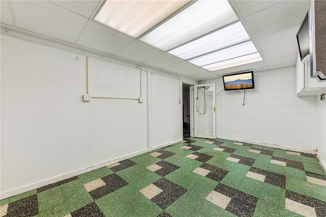 basement featuring a paneled ceiling