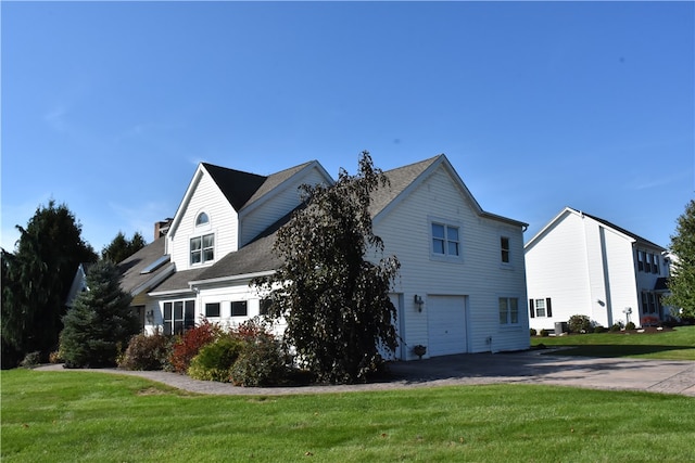 view of home's exterior featuring a garage and a yard