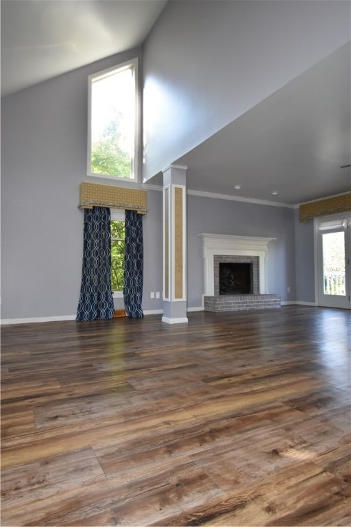 unfurnished living room with dark wood-type flooring and a wealth of natural light