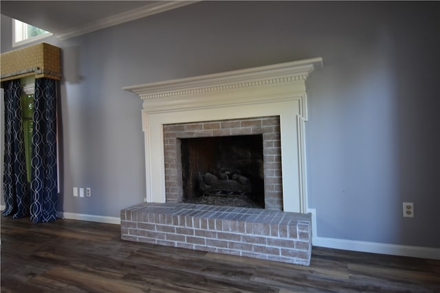 details featuring ornamental molding, hardwood / wood-style flooring, and a fireplace