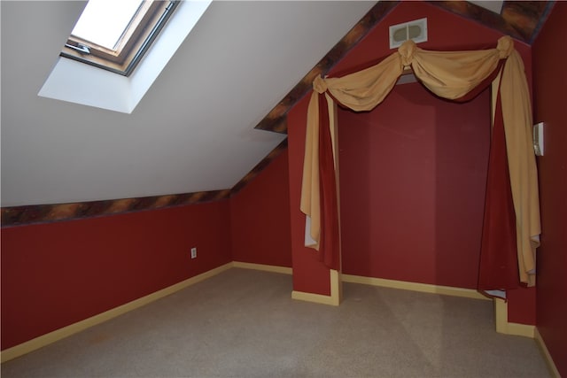 bonus room with vaulted ceiling with skylight and carpet