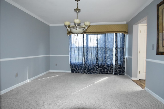 spare room with an inviting chandelier, ornamental molding, and carpet