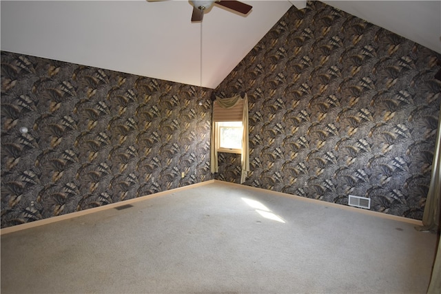 spare room with lofted ceiling, ceiling fan, and carpet floors